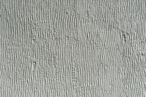 Rough white plastered wall with vertical textured lines creates a minimalist Stock Photos