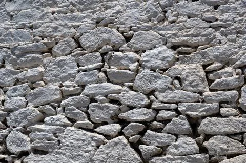 Rough white stone wall for use as a background texture Foto stock