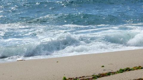 Rough white waves crashing on sandy beach. Slide right. Stock Footage 109263294