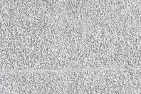 Rough whitewash or white plaster wall under direct sunlight, full-frame Photos