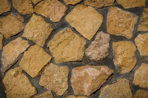 Rough wild stone masonry background Stock Photos