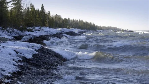 Rough winter waves crash on Lake Superior shoreline in Michigan 4K Stock Footage 100423613