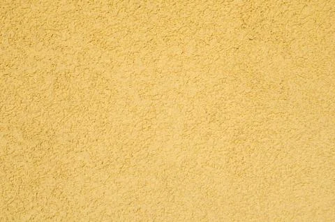 Rough yellow plaster texture Stock Photos