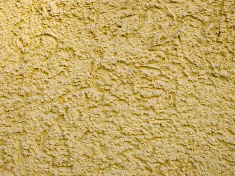 Rough yellow plaster texture Stock Photos