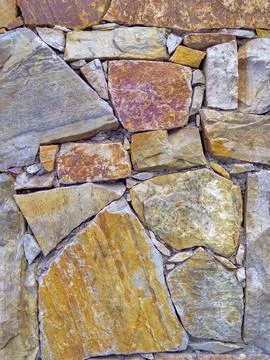 Roughly cut stones wall texture. Natural material background Stock Photos
