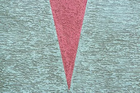 Roughly grooved surface with red wedge Stock Photos
