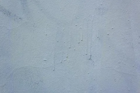 Roughly painted wall with dark blue paint. Evidence of blue paint. Beautiful Stock Photos