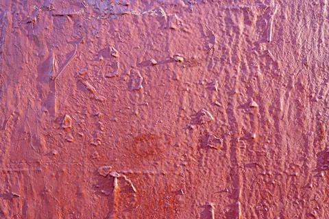 Roughly painted wall with dark red paint. Evidence of red paint. Beautiful Stock Photos