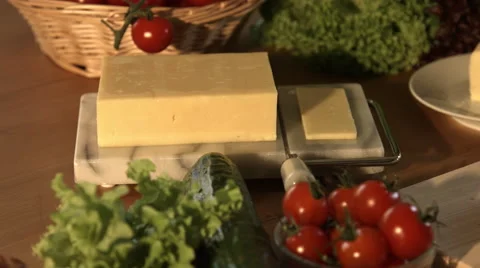 Roughly Slicing A Block Of Cheese In Kitchen 4K Stock Footage 62453597