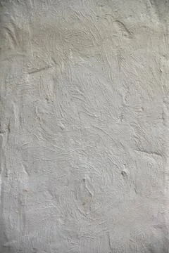 Roughly treated white putty wall with furrows. Texture wallpaper. Stock Photos