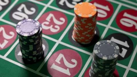 Roulette table with casino chips placed on numbered betting fields Stock Footage 336404547