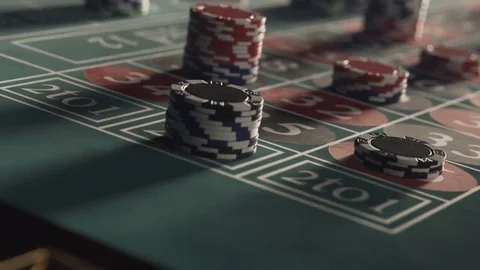 Roulette table with casino chips stacking on a bet 動画素材 77745571