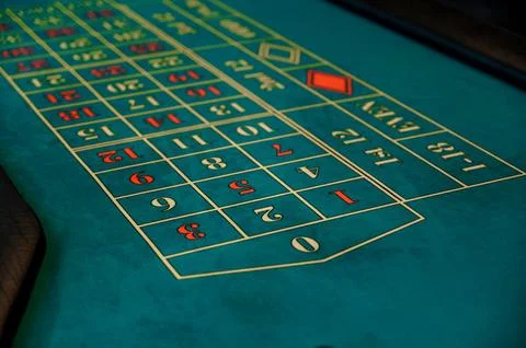Roulette table layout with numbers and betting options in casino setting Stock Photos