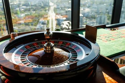 Roulette wheel by panoramic window in daylight Stock Photos