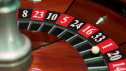 Roulette wheel in rotation with spindle visible and ball settled in pocket 1 Stock Footage 336406322