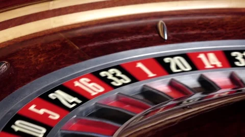 Roulette wheel running and stops with white ball on 33 Stock Footage 59857560