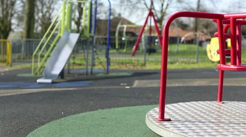A round about spinning at an empty playground 스톡 동영상 35884191