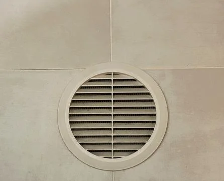 Round Air Vent on Ceiling Tile Background With Minimal Industrial Design Stock Photos