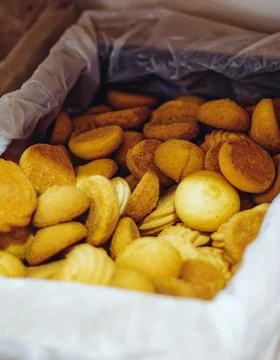 Round and flaky biscuits piled together. Crumbs scatter around the edges. Soft Stock Photos