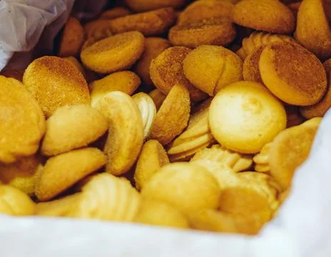 Round and flaky biscuits piled together. Crumbs scatter around the edges. Soft Stock Photos