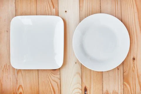Round and square empty clean plates Stock Photos