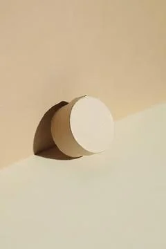 Round beige and white geometric shape on beige background Stock Photos