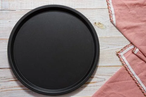 Round black empty tray close up top view on table Stock Photos