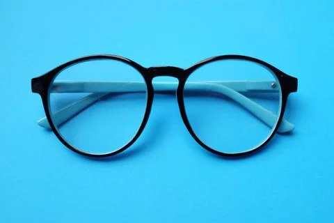Round black Eye Glasses isolate on a blue Background Stock Photos