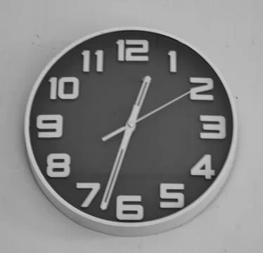 Round Black Wall Clock Over White Stock Photos