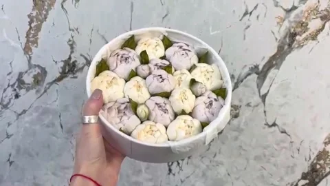 Round box with marshmallows in the form of pink and lilac peonies. Stock Footage 295691930