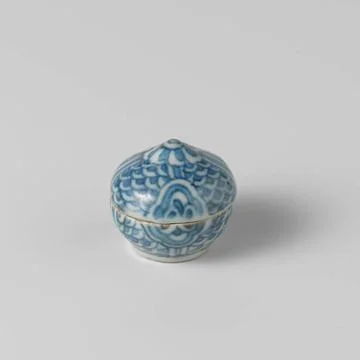 Round Box with a Wave Pattern and Blossoms. Round box of porcelain with a ... Stock Photos