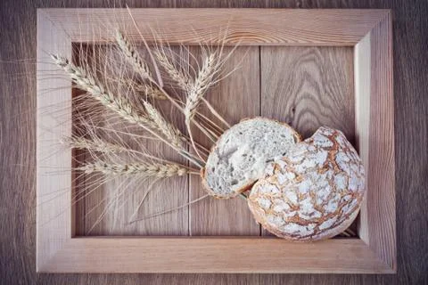 Round bread and spikelets Stock Photos