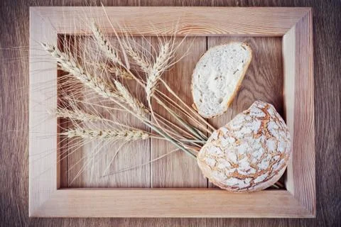Round bread and spikelets Stock Photos