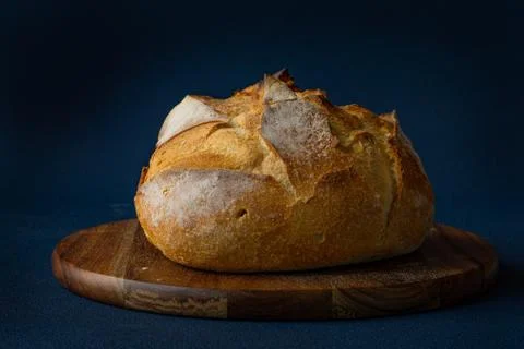 Round Bread on cutting board. Concept: bakery, healthy live. Stock Photos