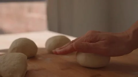 Round bread dough before fermentation on the table Stock Footage 247376750