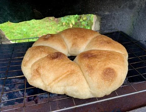 Round bread on the grill over the coals, baking bread Stock Photos