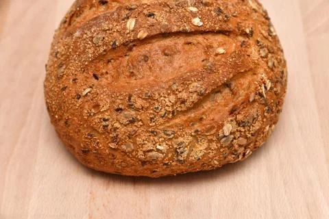 Round bread isolated on kitchen plank Stock Photos