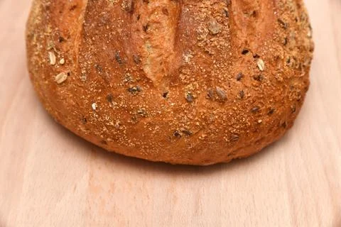 Round bread isolated on kitchen plank Stock Photos
