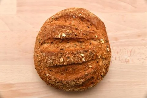 Round bread isolated on kitchen plank Stock Photos