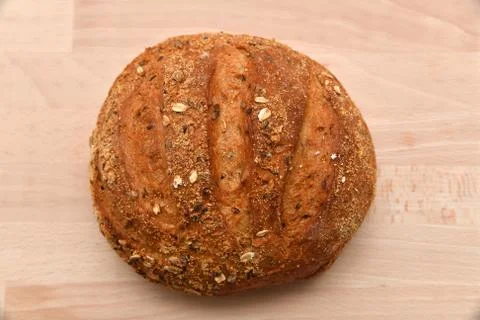 Round bread isolated on kitchen plank 스톡 사진