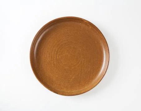 Round brown earthenware dinner plate Stock Photos