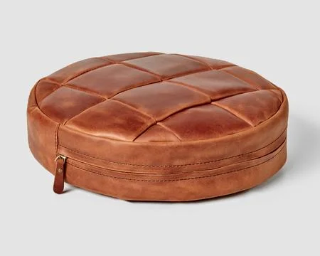 Round brown leather patchwork floor cushion with side zipper Stock Photos