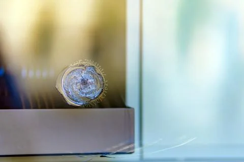 Round bullet impact mark on armored laminated glass Stock Photos