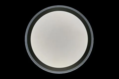 Round burning ceiling lamp isolated on black background Stock Photos