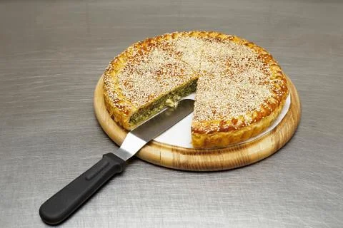 Round cake with an already cut piece. on the table. Stock Photos