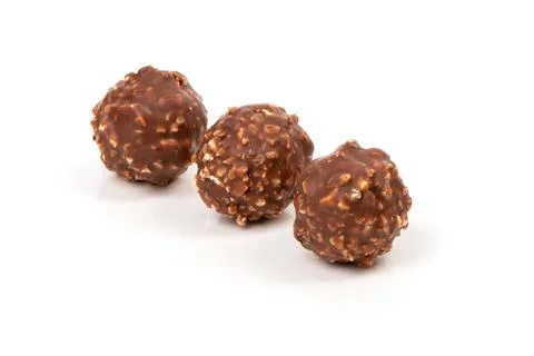 Round candy in a gold package and a paper capsule for a mini cupcake. Stock Photos