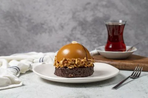 Round caramel cake. Hazelnut and cream portion cake Stock Photos