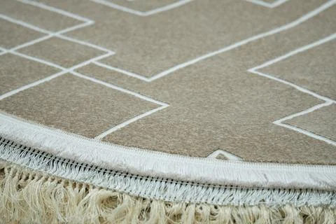 Round carpet edge with geometric pattern and fringe Stock Photos