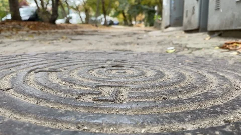 Round cast iron manhole cover on sidewalk. Stock Footage 124257980
