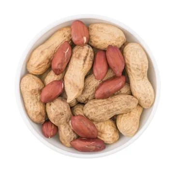 Round ceramic bowl of peanuts in shells. Stock Photos